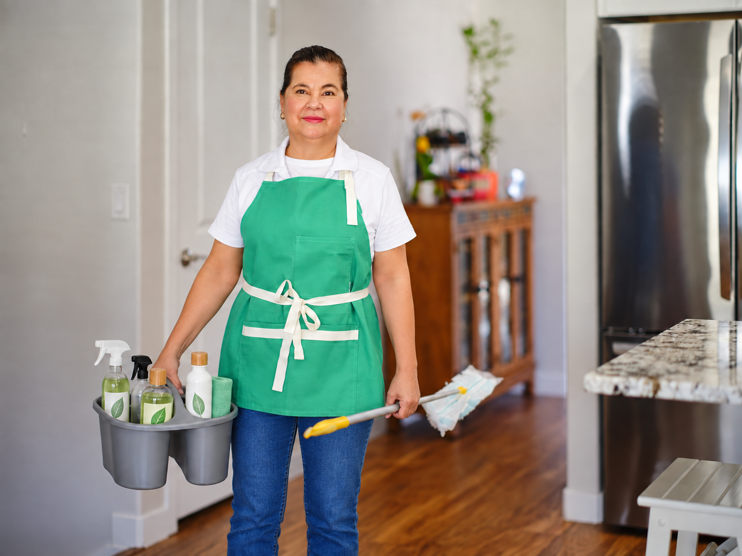 Greener Cleaner team member carrying eco-conscious cleaning supplies